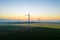 Aerial view of Eolian generators in a beautiful wheat field. Eolian turbine farm. Wind turbine silhouette. Wind mill turbines. Wi