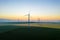 Aerial view of Eolian generators in a beautiful wheat field. Eolian turbine farm. Wind turbine silhouette. Wind mill turbines. Wi