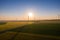 Aerial view of Eolian generators in a beautiful wheat field. Eolian turbine farm. Wind turbine silhouette. Wind mill turbines. Wi