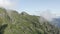 Aerial view epic natural cliff terrain green grass at cloudy smoke organic natural environment