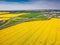 Aerial view of exit and slip road to D1 highway between Prague and Brno EXIT 8 in spring with yellow rapeseed fields around