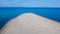 Aerial view of exotic long sand beach with sea on both sides