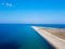 Aerial view of exotic long sand beach with sea on both sides