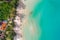 Aerial view of exotic turquoise sea with white beach green tree island