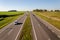 Aerial view of the expressway through the countryside. Beautiful sunny day