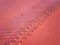 Aerial view of extremely salty lake with wooden logs for salt extraction in the pink water, natural abstract background