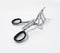 Aerial view of eyelash curler with black handles isolated on white background. Beauty accessory, close up