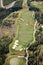 An aerial view of a fairway, green and sand bunkers on a golf course