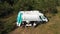 An aerial view of a family holiday near a motorhome in the woods . Travel concept