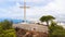 Aerial view of family of tourists posing near cross La Cruz De Benidorm in Spain