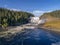 Aerial view famous waterfall Tannforsen northern Sweden, with a rainbow in the mist and rapid flowing cascades of water