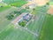 Aerial view of farm, red barns, corn field in September. Harvest season. Rural landscape, american countryside. Sunny morning