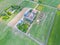 Aerial view of farm, red barns, corn field in September. Harvest season. Rural landscape, american countryside. Sunny morning