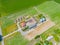 Aerial view of farm, red barns, corn field in September. Harvest season. Rural landscape, american countryside. Sunny morning