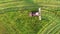 Aerial view of farmer In Tractor Mowing Green Grass For Hay Or Livestock Feed