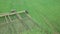 Aerial view of a Farmer in tractor prepares for plowing a field