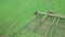 Aerial view of a Farmer in tractor prepares for plowing a field