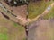 Aerial view at a farming land with line of trees, little creek and a puddle.