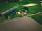 Aerial view of farmland with red barn and houses and harvest field in Finland