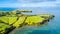 Aerial view on a farmland on the shore of sunny harbour. Whangaparoa peninsula, Auckland, New Zealand