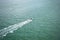 Aerial view of fast motor boat sails on the boundless sea