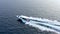 Aerial view of fast speed boat gliding on the water surface