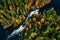 Aerial view of fast and wooden cabin in beautiful orange and red autumn forest. Oulanka National Park, Finland