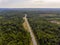 Aerial view on federal intercity highway in a pine forest in Russia in summer