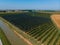 Aerial view of a field with peach trees. Farm for growing fruits. Processing and service. Productivity and harvest. Water channel