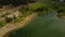 Aerial view of a field, Pineview Reservoir Lake, Utah, and cars passing by on the road near the lake