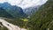 Aerial view of a field among the rocks in the alpine mountains