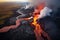 Aerial view of fiery lava flowing down the sides of a volcano. Volcanic eruption with lots of smoke plumes, black ash and magma