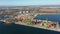 Aerial view filmed by a drone of a containerized cargo terminal of commercial port, business logistics and