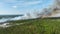 Aerial view of fire department firetrucks extinguishing wildfire burning severely in Florida jungle woods. Emergency