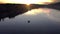 Aerial view of fisherman at the boat on golden sunset river. silhouette of fishermen with his boat, Fisherman life style