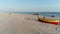 Aerial view of fishermenâ€™s boat on the sand beach. Baltic sea and boat on the beach dron view.