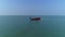 Aerial view fishing boat in the ocean dropping fishing net