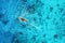 Aerial view of the fishing boat in transparent blue water