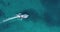 Aerial view of the fishing boat in transparent blue water at sunny day