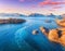 Aerial view of fishing boats, rocks in the blue sea