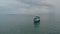 Aerial view of fishing ship in sea water over cloudy sky background