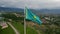 aerial view of the flag of Kazakhstan on the background of the mountains