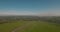 Aerial view. flies between the hills above a road to industrial enterprise. Air pollution from metallurgical plants. 4K