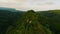 Aerial view flight over mountain ridge covered by green plant at sunlight sea ocean lagoon