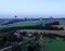 Aerial view flights in large balloons above the forest and field at sunset. Balloon festival. Beautiful landscape at sunset