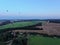 Aerial view flights in large balloons above the forest and field at sunset. Balloon festival. Beautiful landscape at sunset