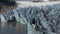 Aerial view floating icebergs of Breidamerkurjokull glacier tongue in Iceland. Drone view snow capped mountains and ice