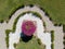 Aerial view of a flowering garden with flowerbeds and vases