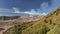 Aerial view fly pass hill to reveal Bromo volcano in a background, Indonesia