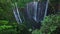 Aerial view fly through trees to Tumpak Sewu waterfall, East Java, Indonesia
